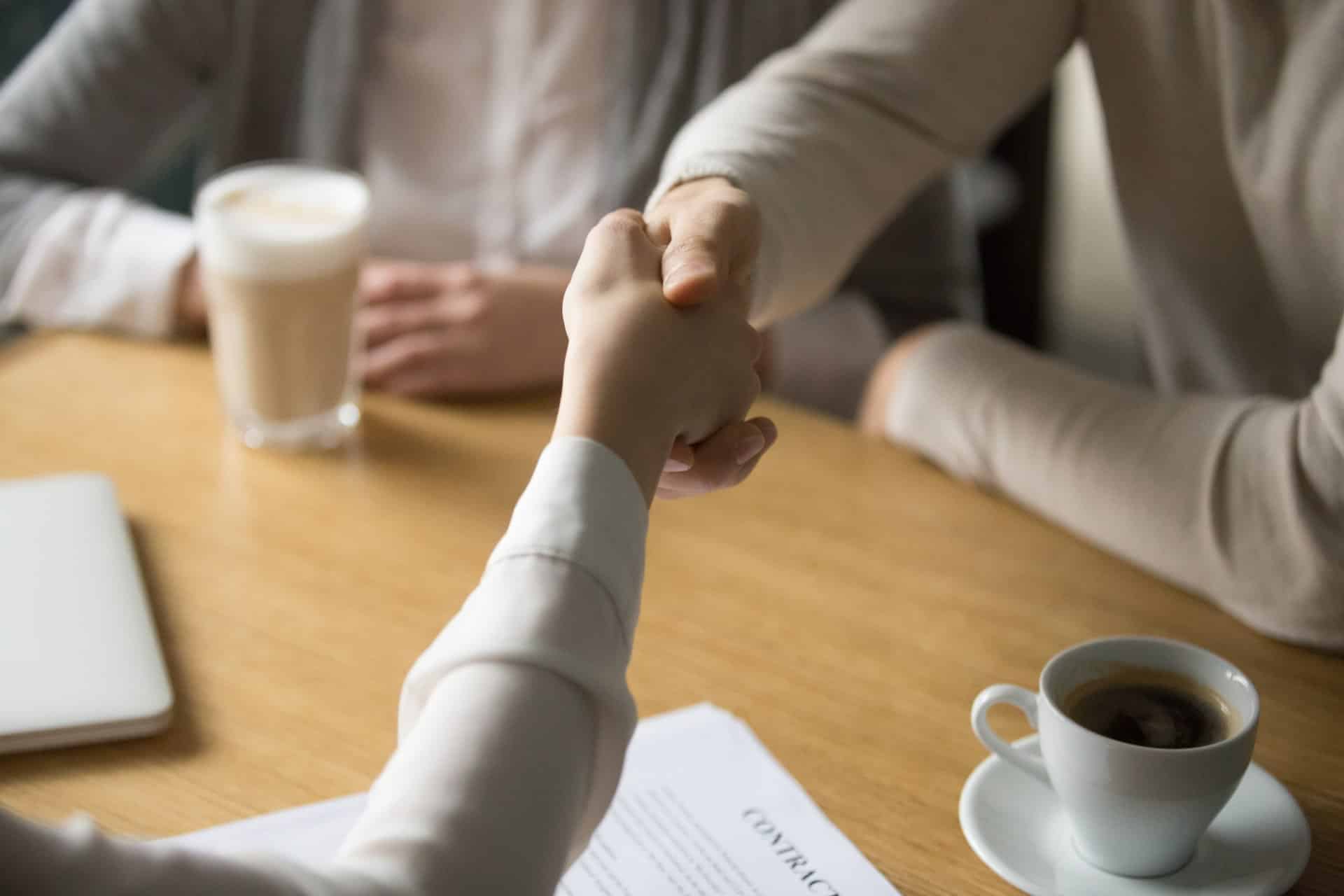 couple handshaking businesswoman making deal cafe close up view 1
