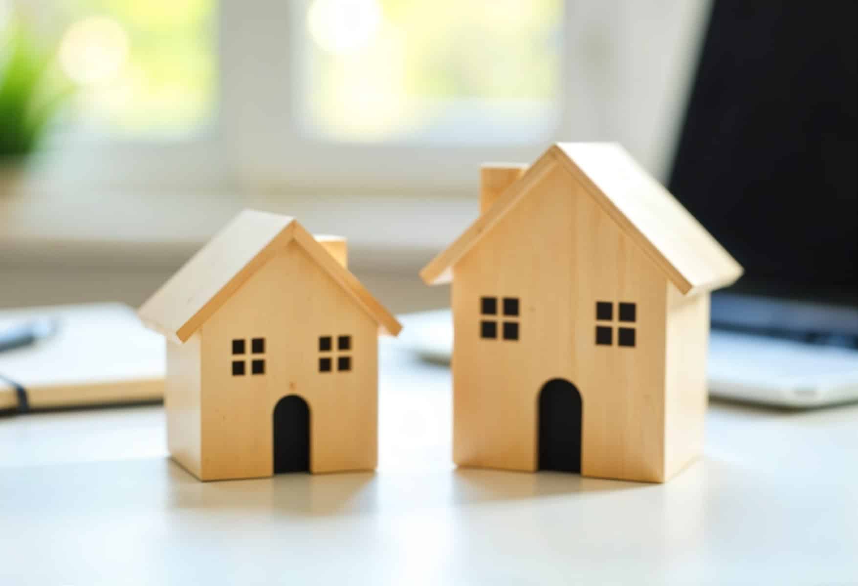 freepik two wooden house models one smaller and one larger 98483