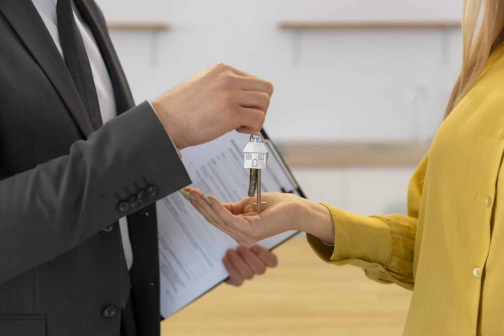 male real estate agent giving keys new house female buyer 1